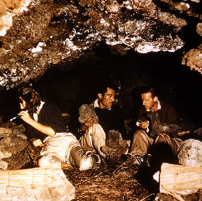 Thor Heyerdahl in the cave belonging to Esteban Haoa, along with Yvonne Heyerdahl